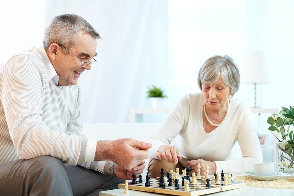 senior couple playing chess at leisure