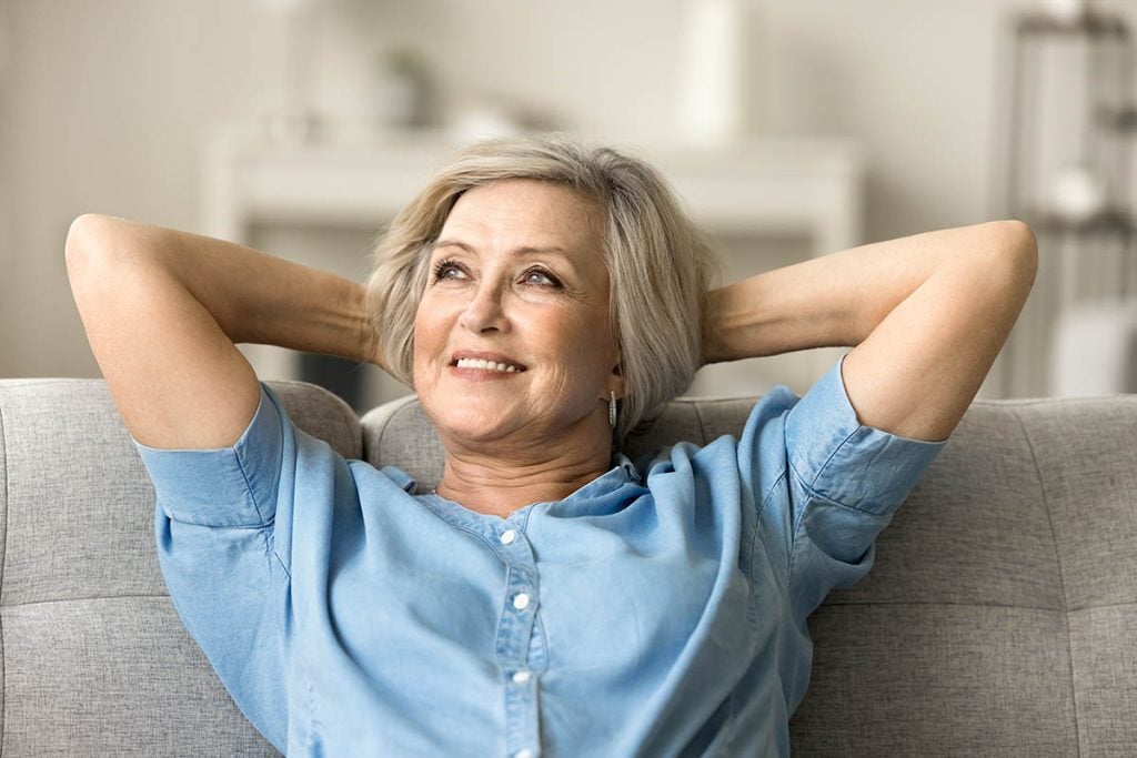 mature woman relaxing on home couch