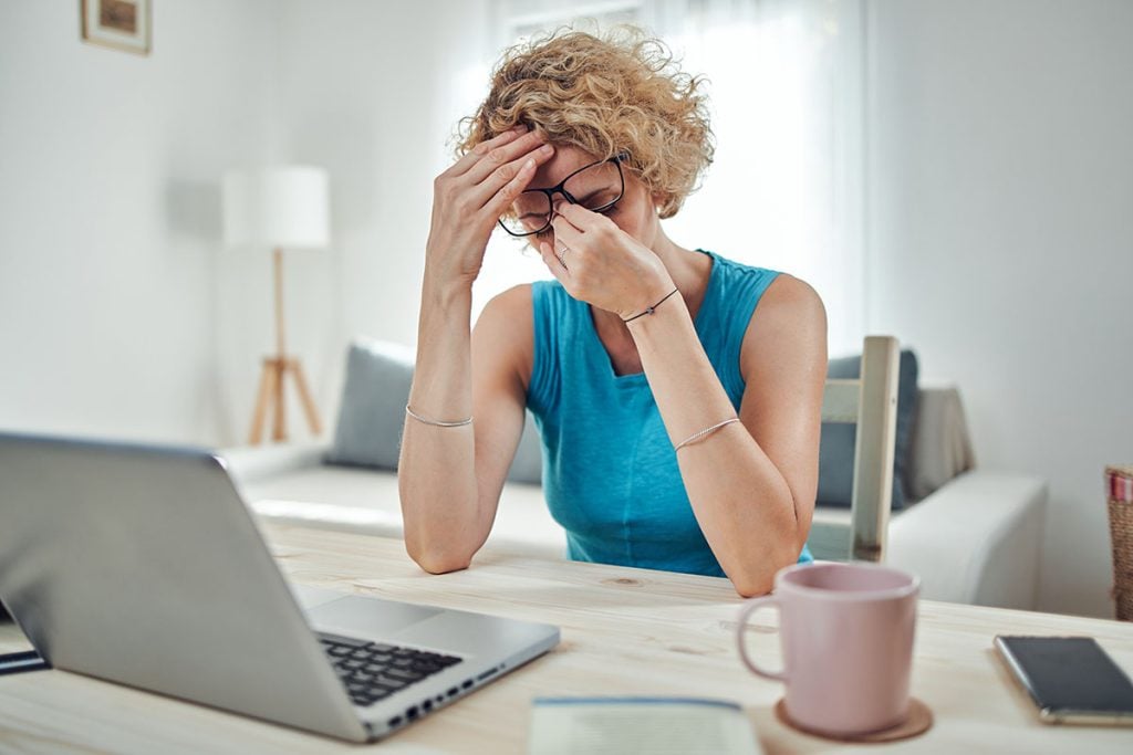 A woman who's tired, in front of her computer