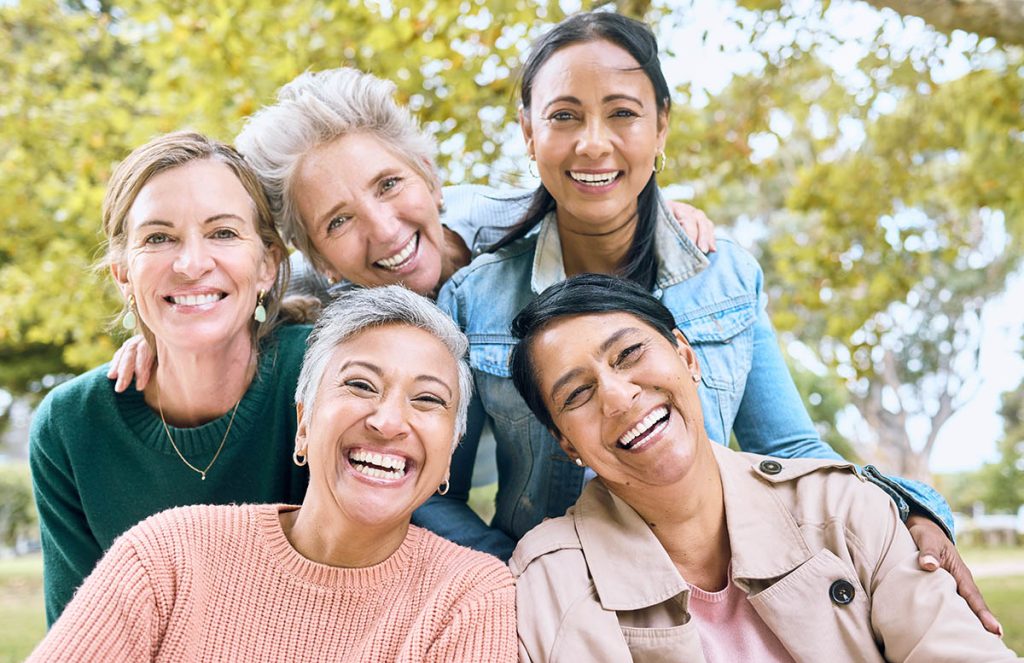 Smile, park and portrait of group of women enjoying bonding, quality time and relax in nature together.