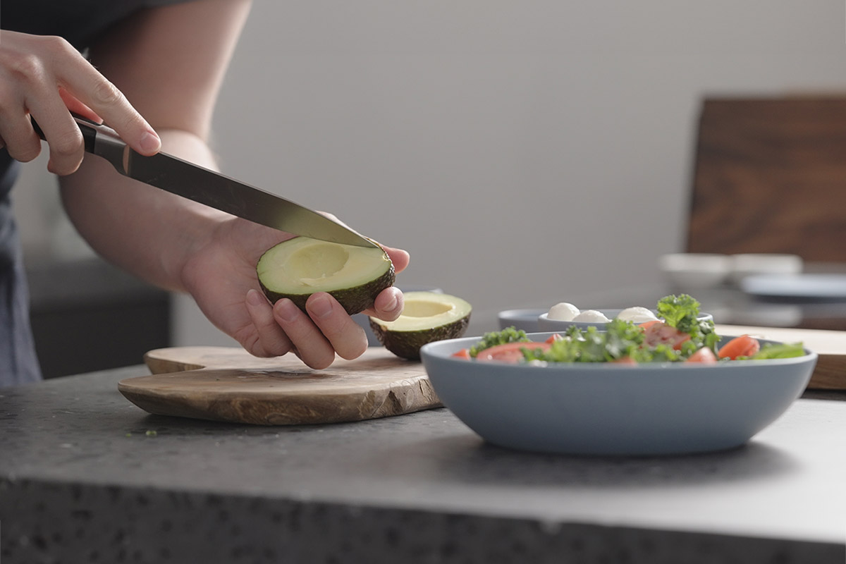 cutting avocado into salad