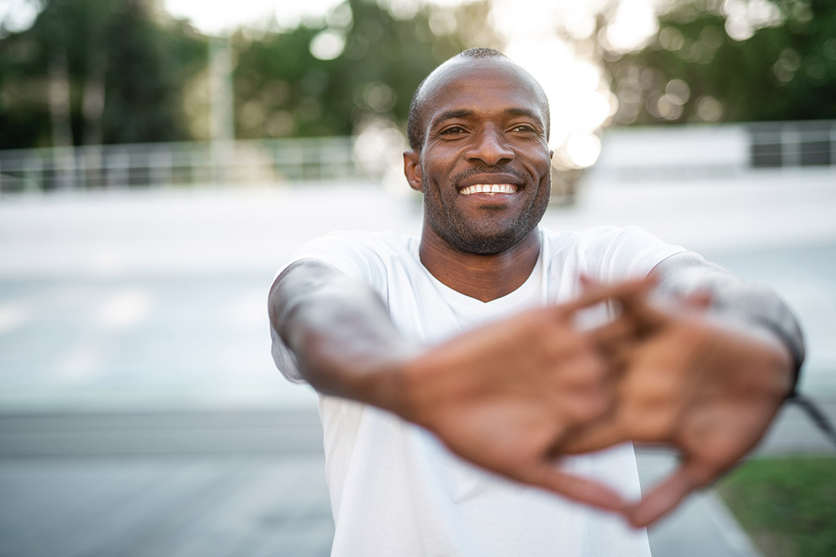 Portrait of cheerful male athlete doing workout.