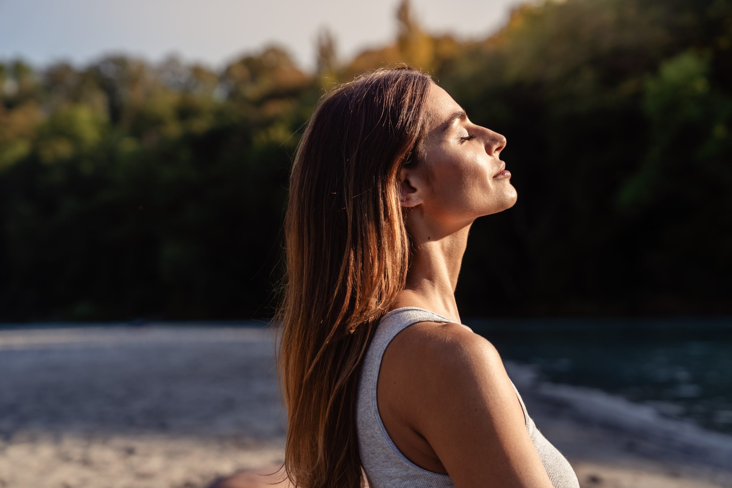 woman facing the sun with long hair