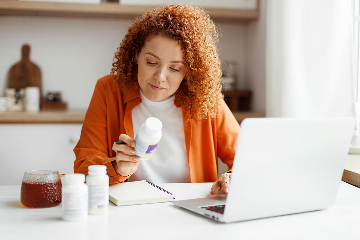 Woman looking at the labels of bottle