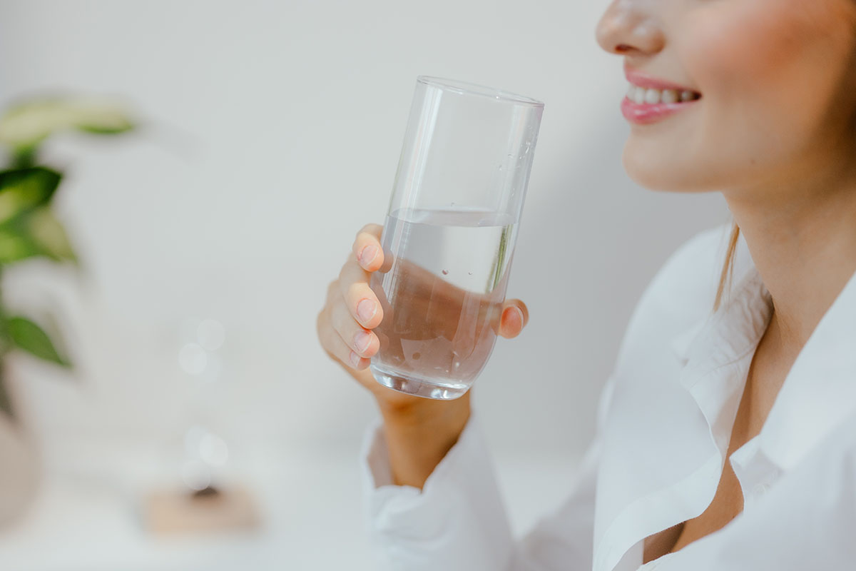 Woman Drinking Water and smiling