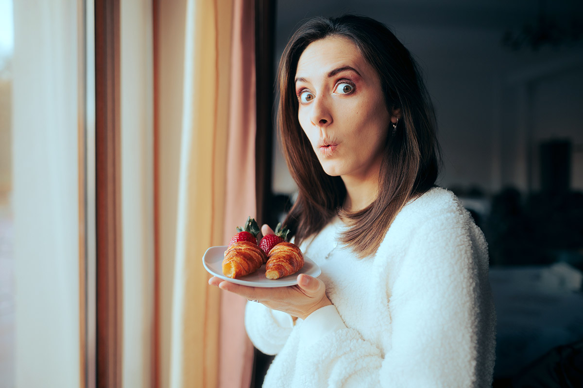 Happy woman having breakfast