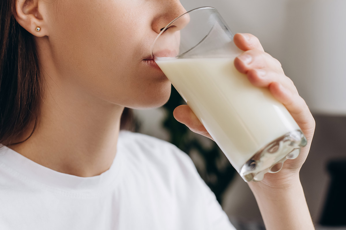  woman drinking milk with calcium for strong bone at home