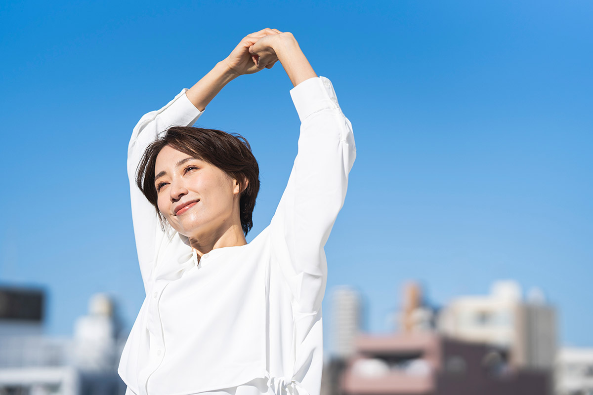 woman stretching on the rooftop on a sunny day