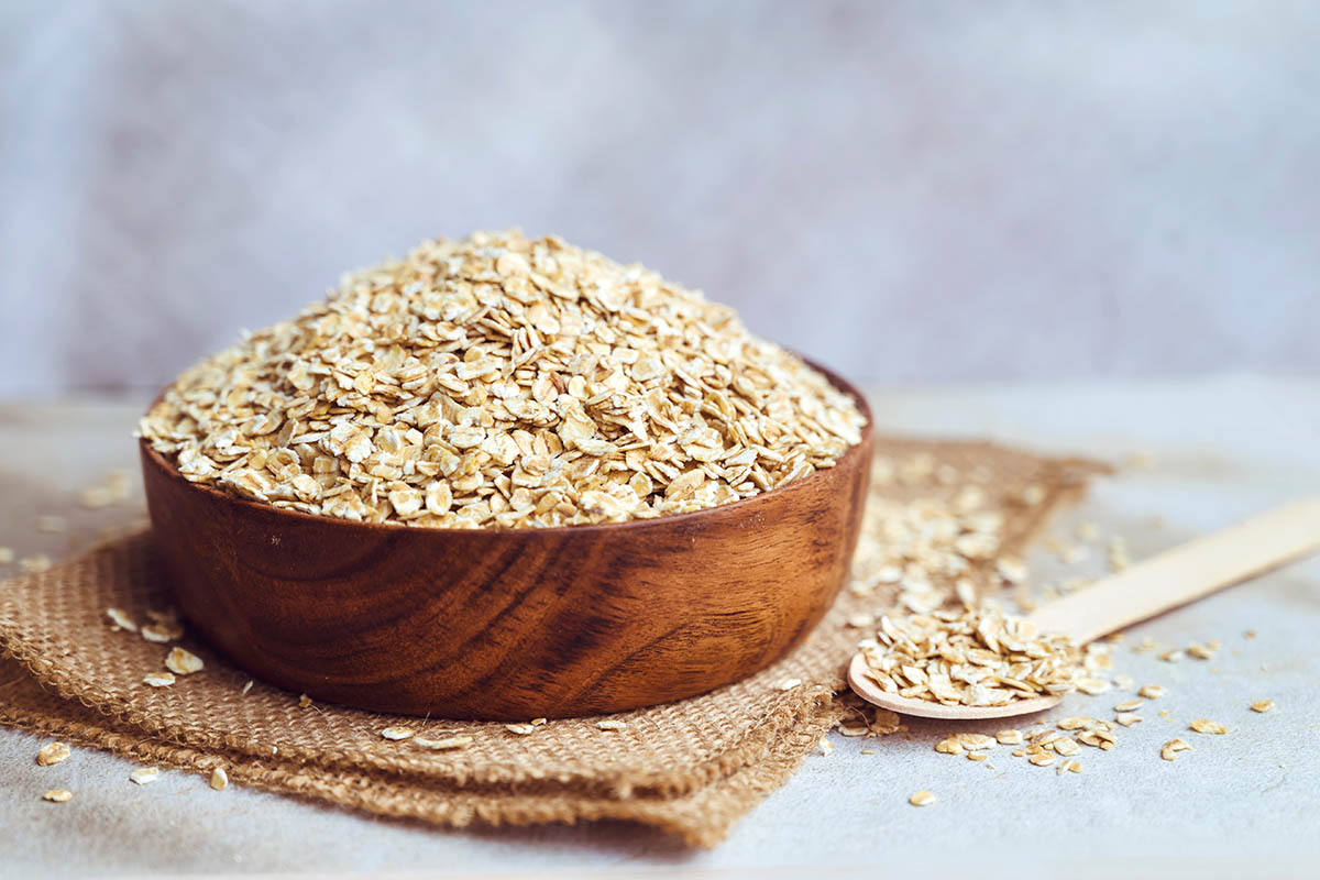 Oats in wooden bowl . Healthy food