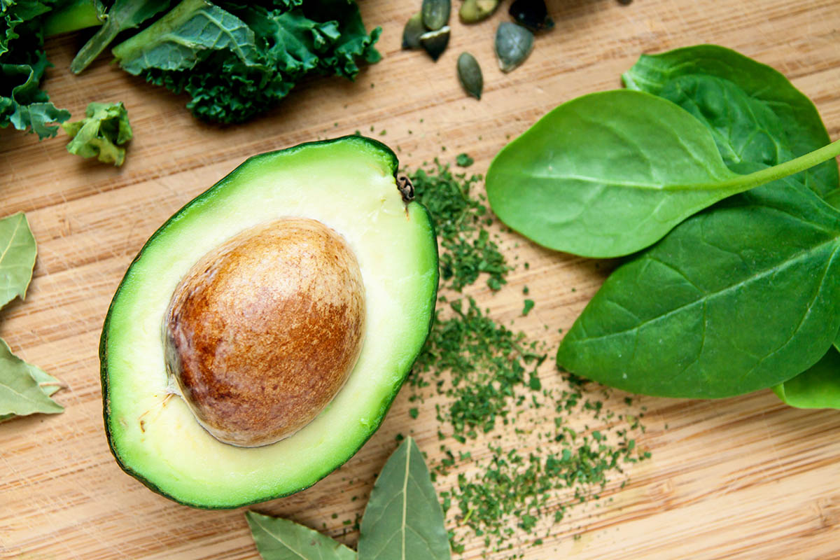 green fresh organic vegetables on wooden board