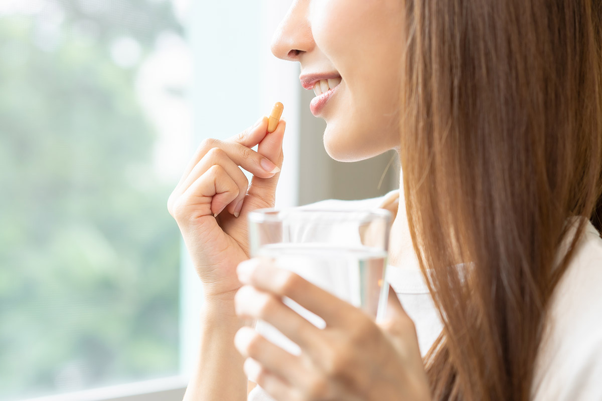 Woman taking supplement